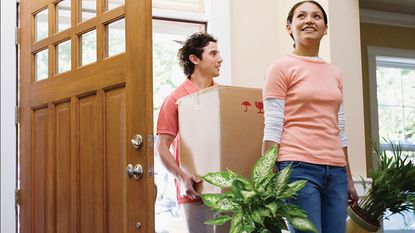 A couple walks through the door of their new house