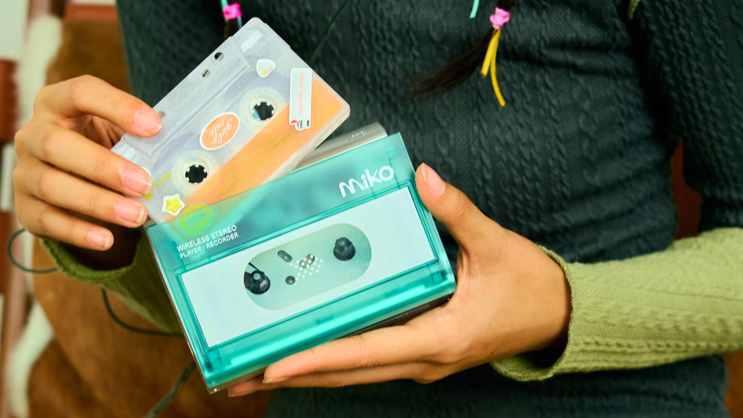 The Gadhouse Miko Cassette Player in a hand, with a cassette being inserted.