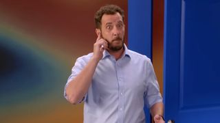 Rick Devens pretends to answer a phone call on Big Brother.