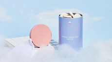 Blueland's laundry tin in a dreamy cloud setting surrounded by bubbles