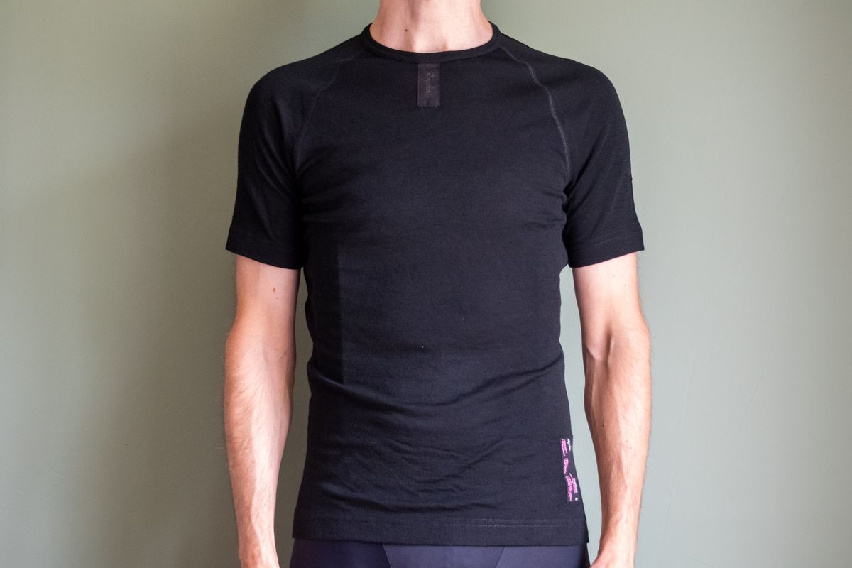 A man wearing a black Rapha merino short sleeve base layer