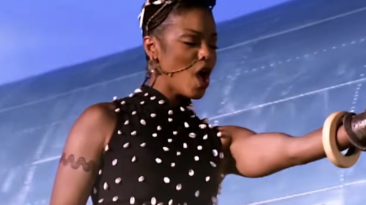 Janet Jackson in a black and white shirt in the music video, "Runaway"