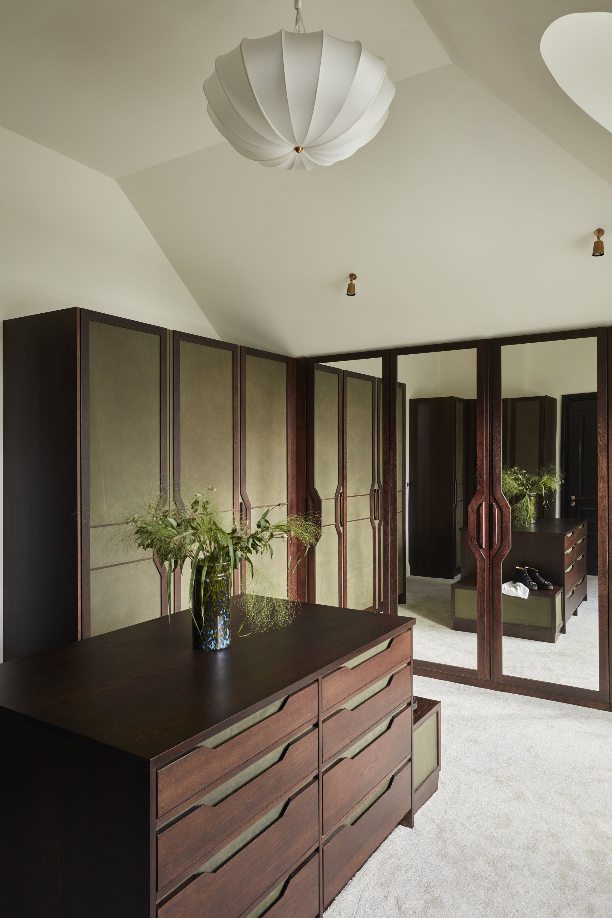 a walk in closet with leather clad cabinetry