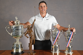Koepka with the Jack Nicklaus trophy and three of his Major trophies in 2018