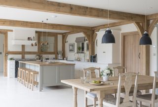 oak frame open plan kitchen with grey units and dining area
