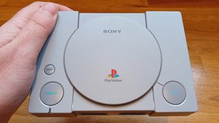 A photo of the PlayStation Classic being held for a review