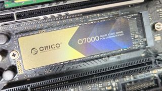 An Orico O7000 SSD slotted into a motherboard