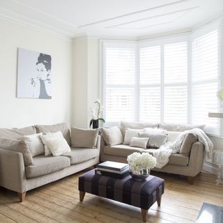 white living room with wooden flooring and sofa set