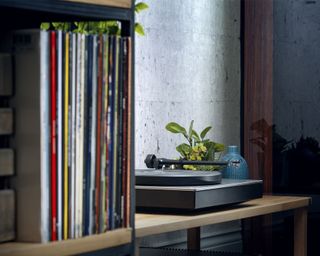 Vinyl storage and a record player on display in a living room