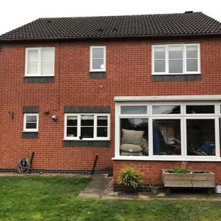 Exterior of house showing a conservatory style extension