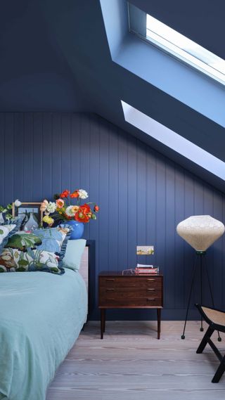 a bedroom painted in dark blue