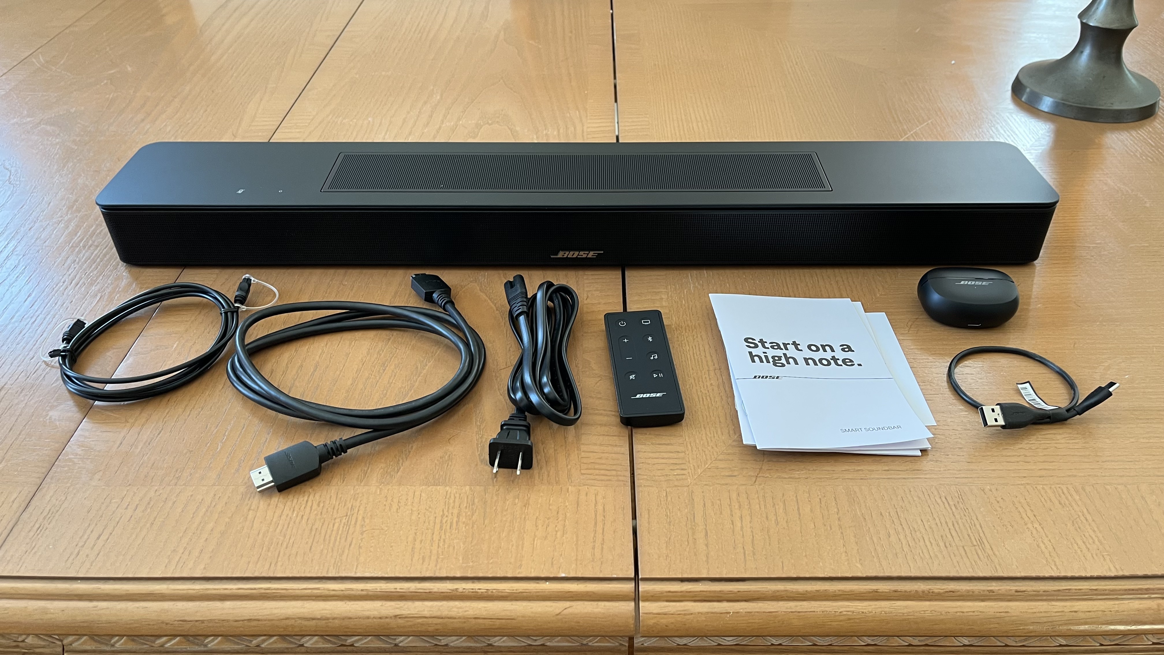 Bose Smart soundbar on table with accessories