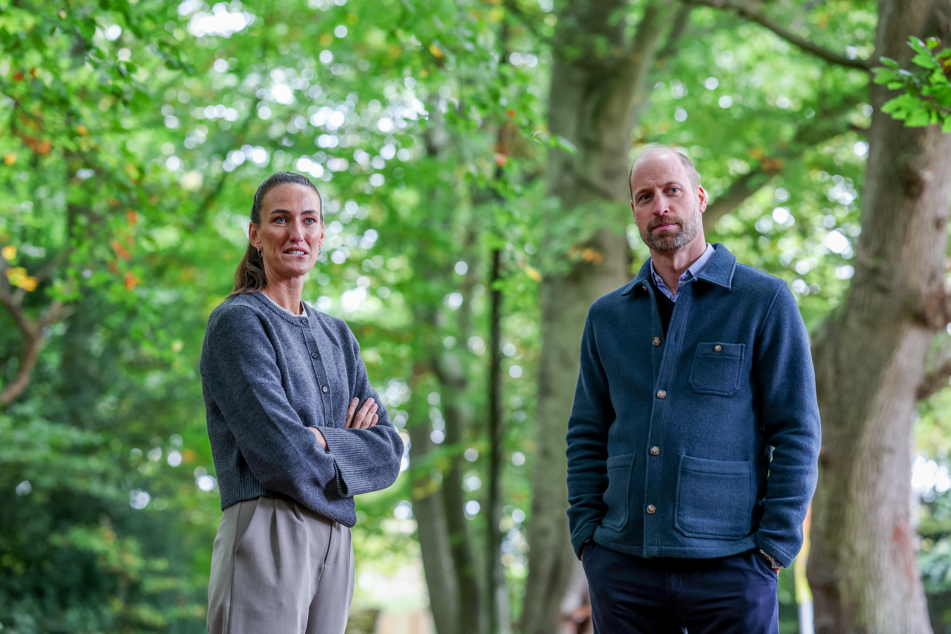 Prince William and Jill Scott posing in the woods