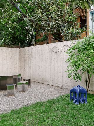 An outdoor courtyard with custom outdoor table, formed from laser cut stainless steel sheets