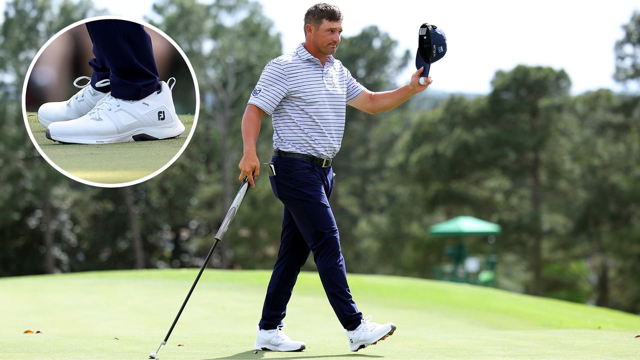 Bryson DeChambeau waves to the crowd whilst walking off the putting green