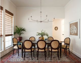 a dining room with table and matching chairs