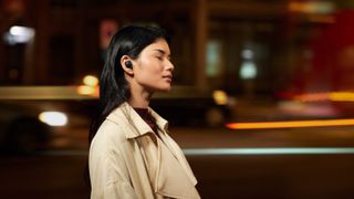 A woman wearing the Sony WF-1000XM4 wireless earbuds