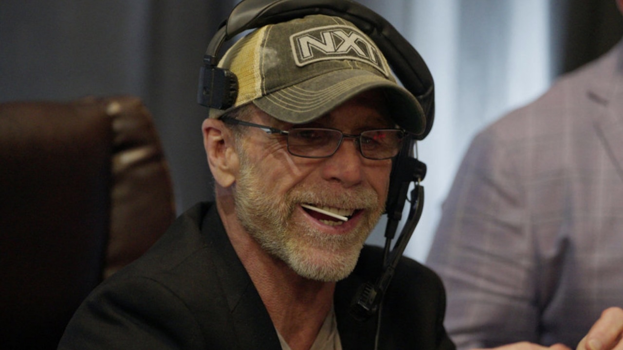 Shawn Michaels wearing NXT hat with lollipop in mouth in The Heartbreak Kid: Becoming Shawn MIchaels documentary