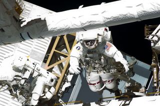 NASA astronauts Greg Chamitoff (right) and Michael Fincke, both STS-134 mission specialists, participate in the mission's fourth spacewalk for construction and maintenance continue on the International Space Station on May 27, 2011.