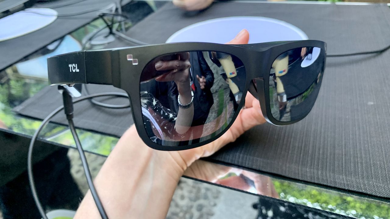 TCL NXTWEAR G glasses held in a hand outside at Milan Design Week