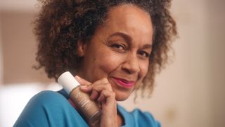 RItamaria, a real woman who loved using no7 serum foundation holding the foundation bottle