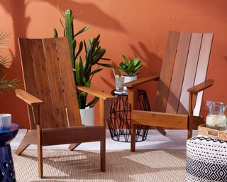 Modern Slatted Wood Adirondack Chairs on patio with painted terracotta color walls