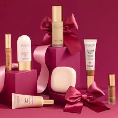 Sculpted by Aimee beauty products on pink blocks, with pink background and bows