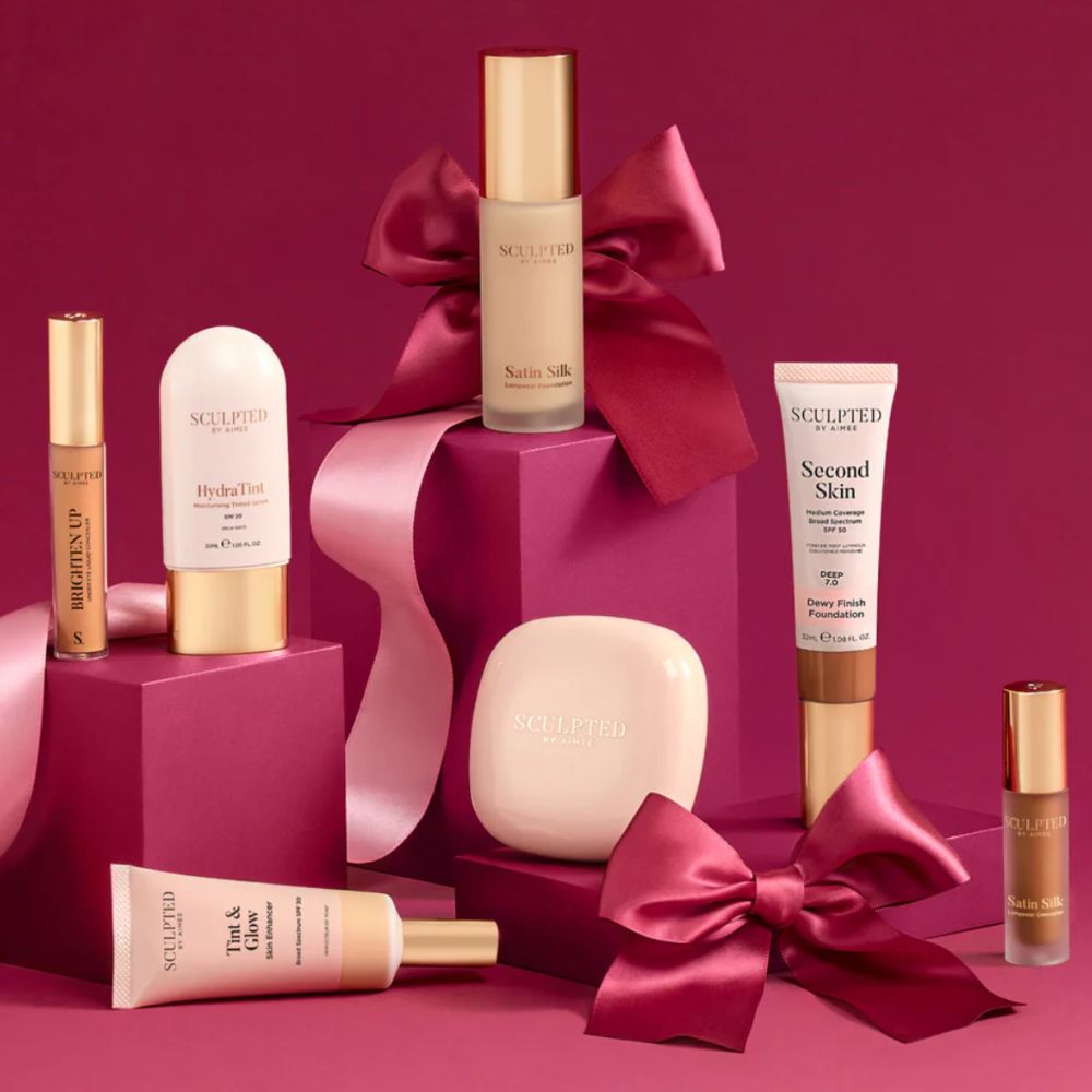 Sculpted by Aimee beauty products on pink blocks, with pink background and bows