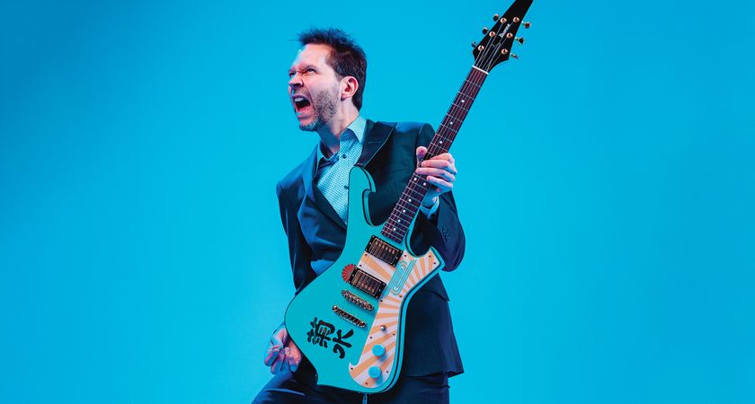 Paul Gilbert poses with his Ibanez Kikusui Fireman, a guitar inspired by a sake bottle