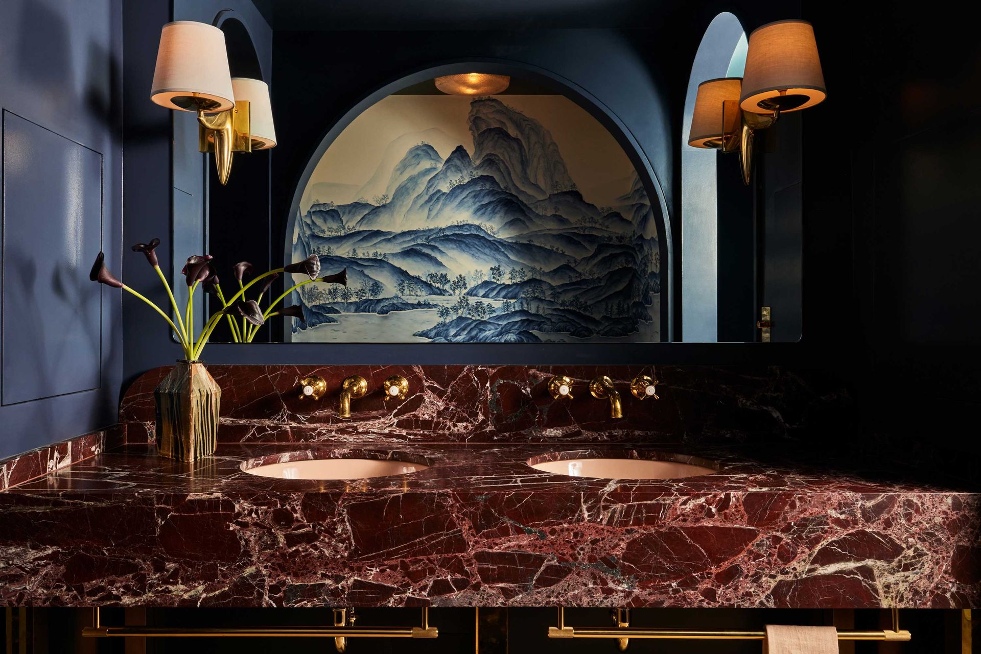 a modern bathroom with red marble vanity