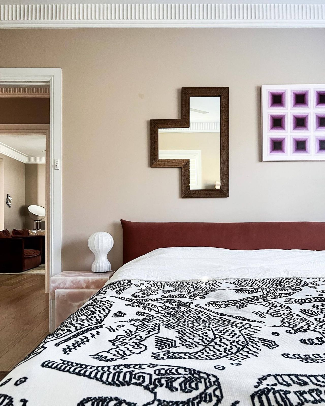 bed with a white and black printed bedspread