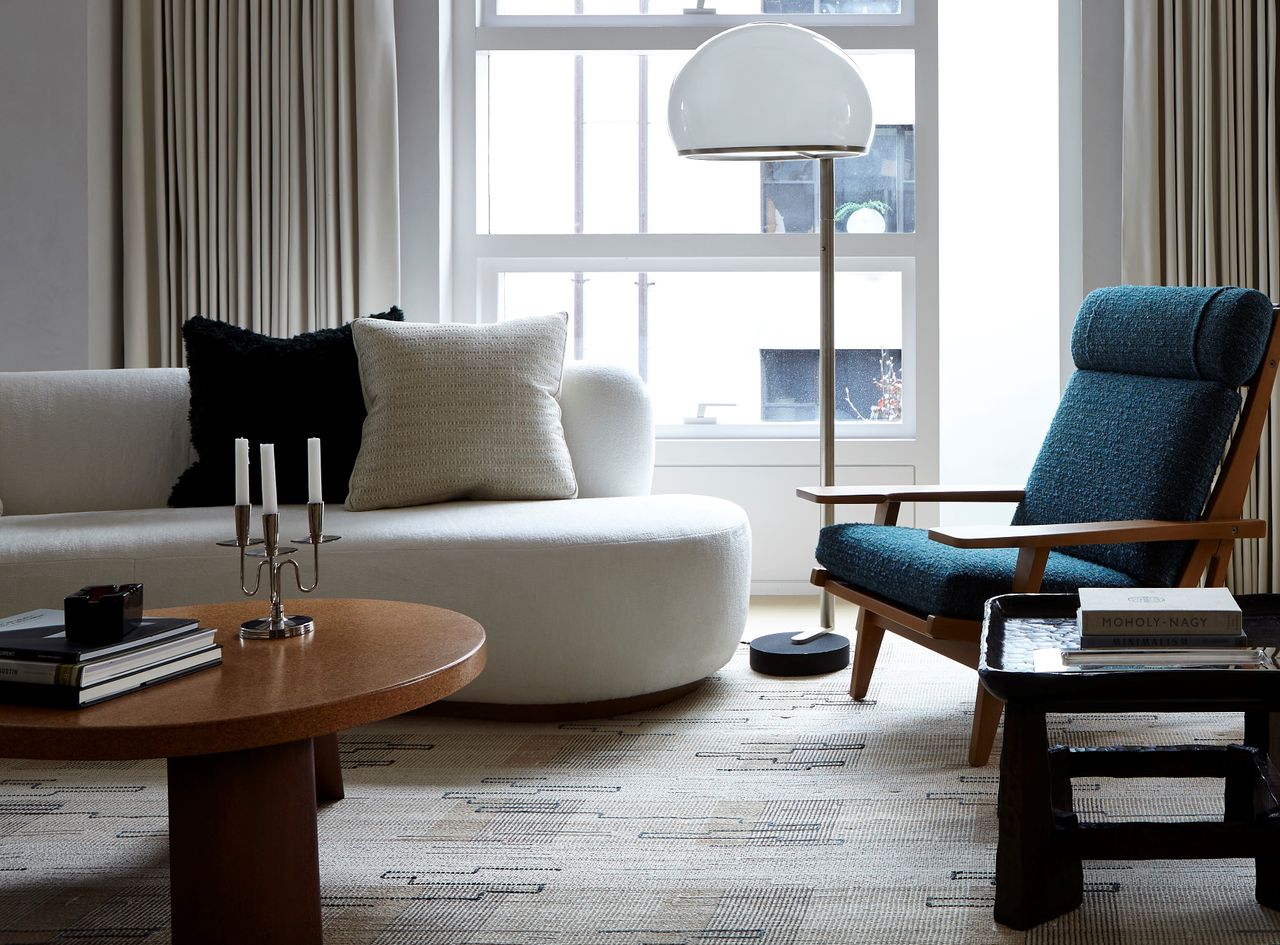 A living room with a textured carpet in muted tones