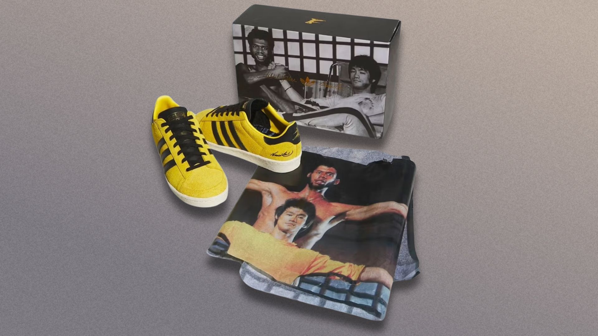 Bruce Lee Adidas trainers on a grey background