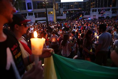 Mourners at a candlelight vigil Sunday night in Orlando for the victims of the Pulse nightclub shooting.