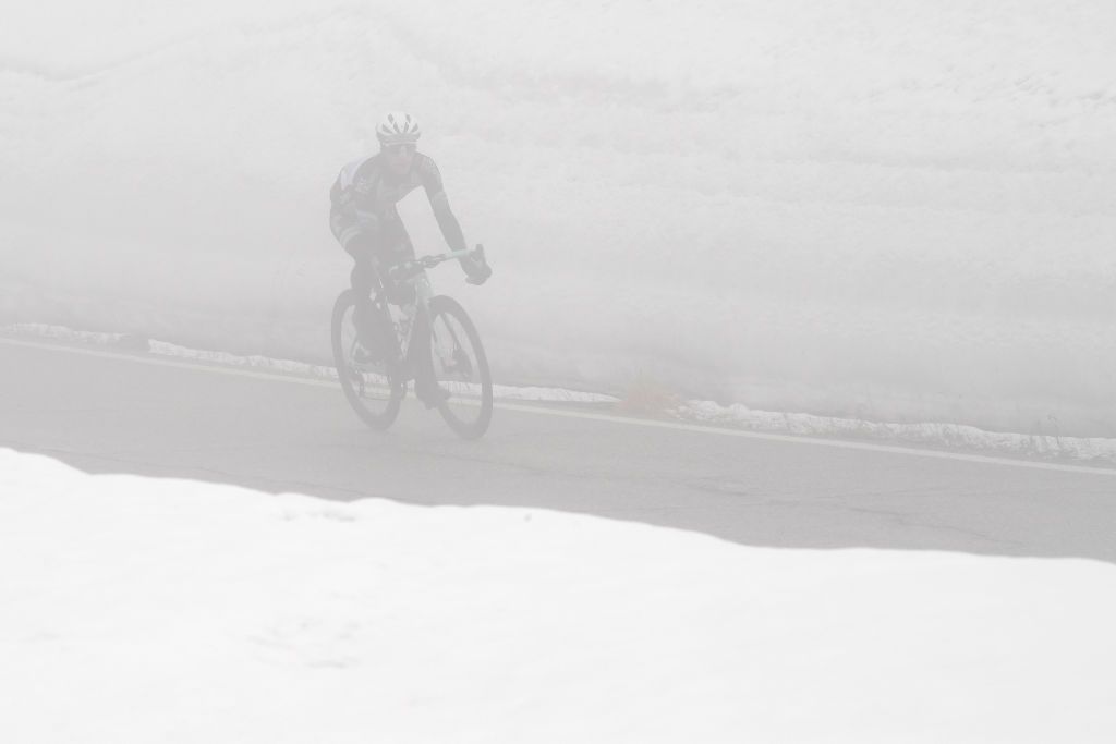 CORTINA DAMPEZZO ITALY MAY 24 Simon Yates of United Kingdom and Team BikeExchange passing through Passo Giau 2233m landscape during the 104th Giro dItalia 2021 Stage 16 a 153km stage shortened due to bad weather conditions from Sacile to Cortina dAmpezzo 1210m Snow girodiitalia Giro on May 24 2021 in Cortina dAmpezzo Italy Photo by Tim de WaeleGetty Images