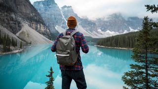 A man taking in the scenic view over Lake Moraine