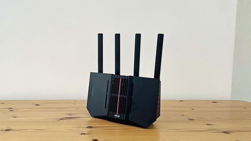 Asus RT-BE92U router on wooden table