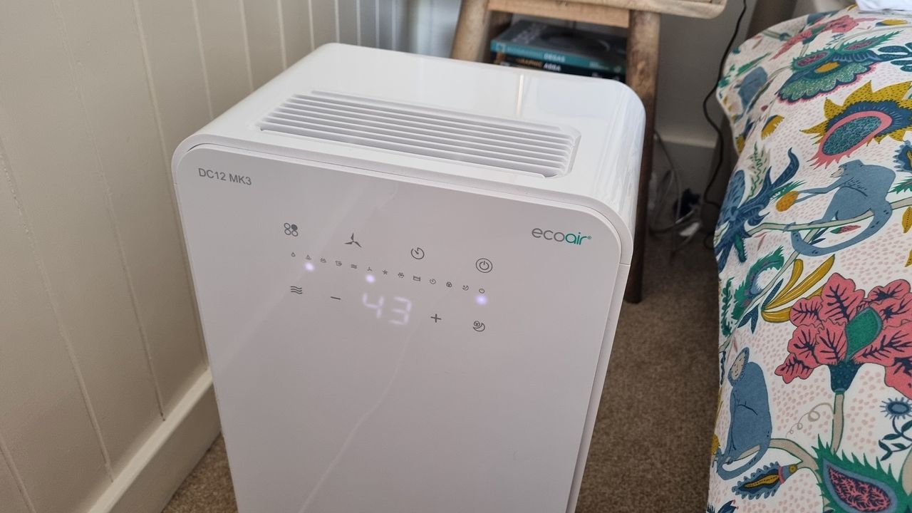 EcoAir DC12 MK3 control panel close up, beside a bed