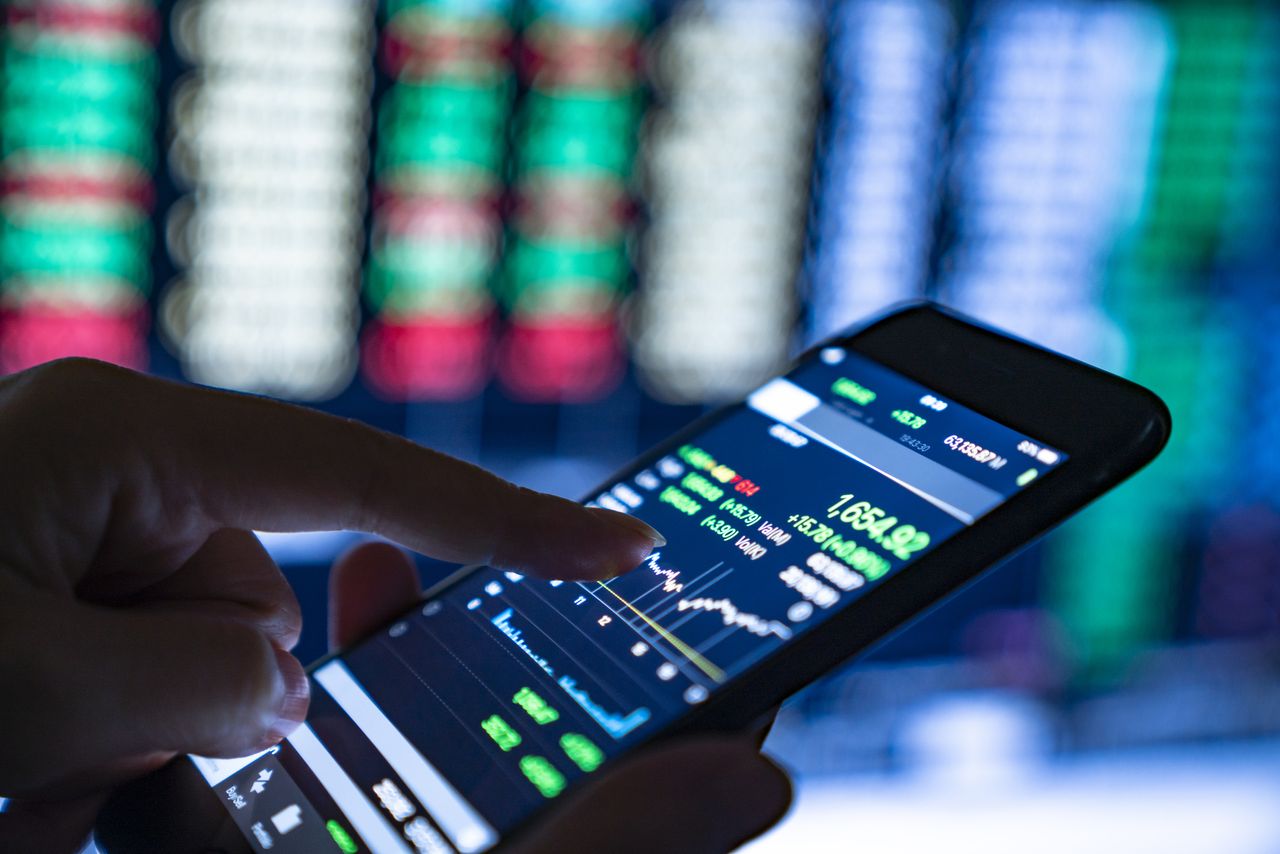 Close-up of hands of businesswoman on trading apps