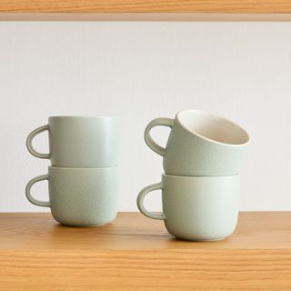 Mint green mugs stacked up