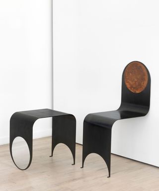 Thin metal chair and side table with circular and semi circular cut outs