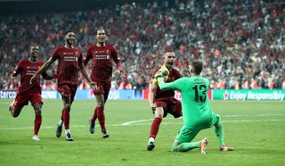 Liverpool’s Jordan Henderson and goalkeeper Adrian celebrate winning the Super Cup