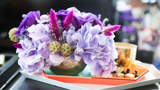 Purple flower arrange in shallow vase