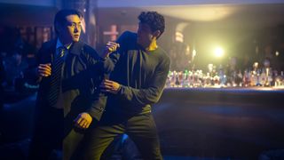 Jang and Owen work together in a fight in a bar in The Recruit season 2