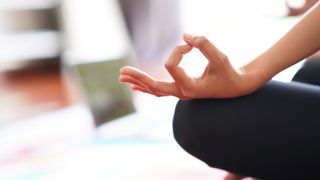 Woman's hand in mindful pose practicing how to breathe better