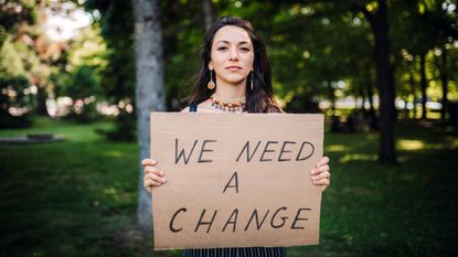 woman holding sign up 