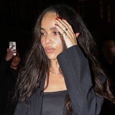 Zoe Kravitz wearing a black blazer, and satin tank top in Paris