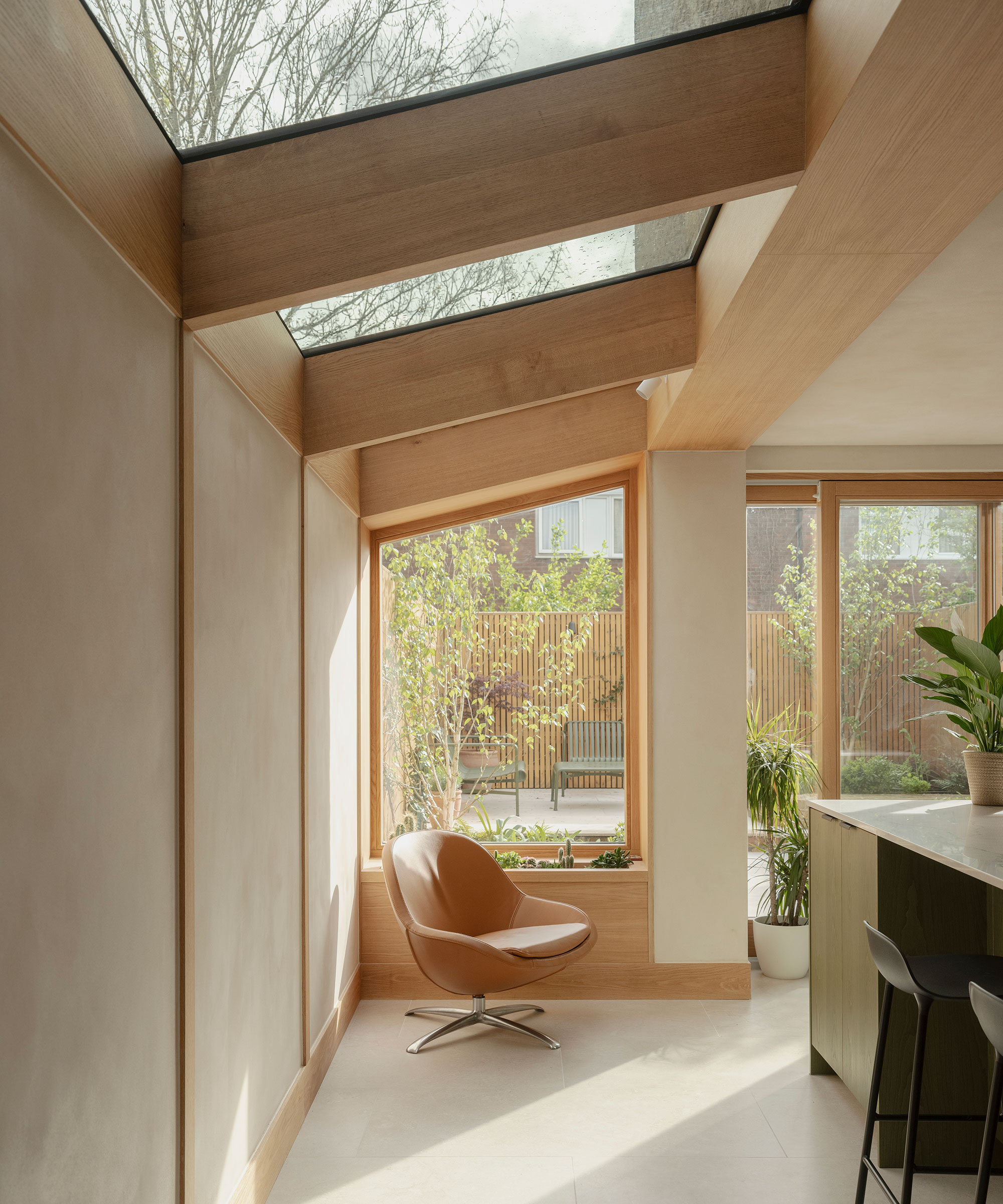 modern side extension with rooflights and angled picture window