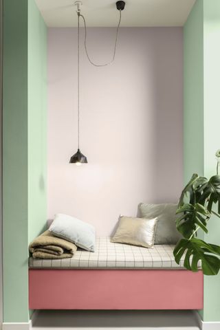 pale purple and green walls with bench seat and plant