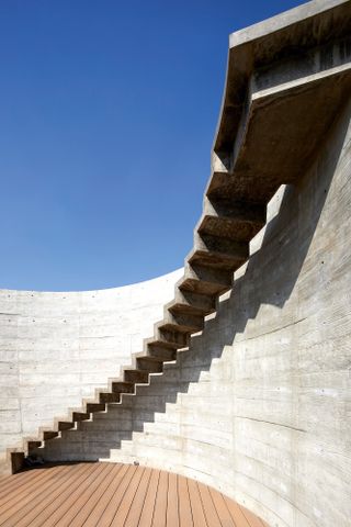 Concrete outdoors staircase at Surat House by Matharoo Associates in India